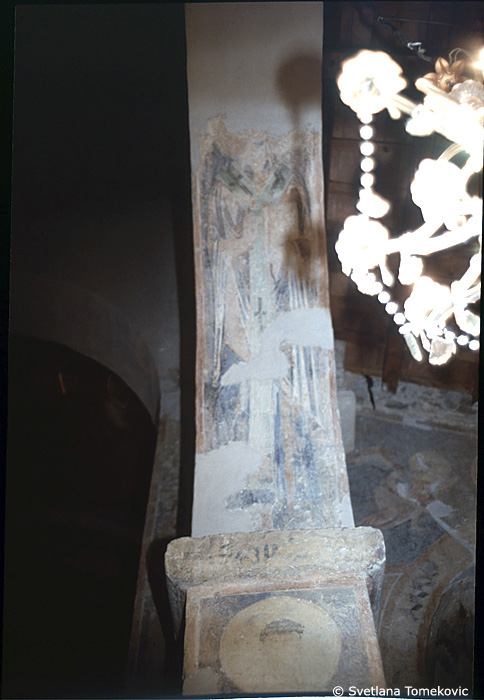 Fresco, first arch, south, top of east face, showing Saint? 