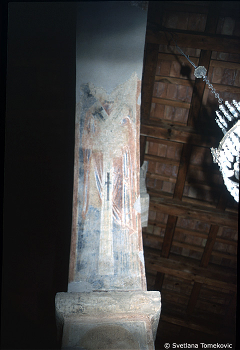 Fresco, south aisle, top of second arch, east face, showing Saint?