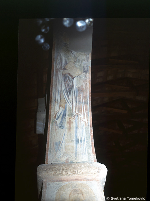 Fresco, south aisle, third arch, west intrados showing Saint?
