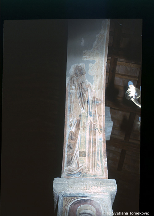 Fresco, south aisle, top of fourth arch, east face, showing Saint?