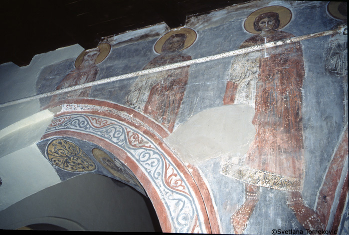 Fresco, nave, north aisle, spandrel and above arch showing saints?