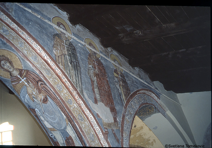 Fresco, nave, north aisle, spandrel and above arch showing saints?