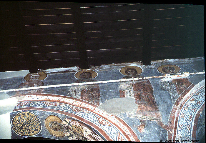 Fresco, nave, north aisle, south wall, east end, spandrel and above arch, showing three martyrs