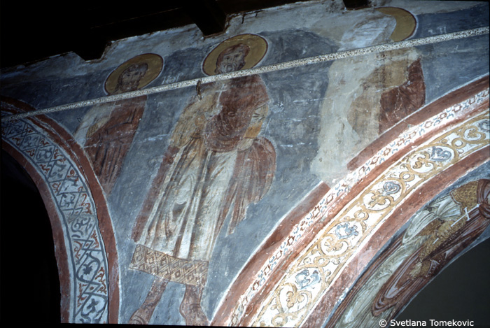 Fresco, nave, north aisle, south wall, spandrel and above second and third arches, showing saints?