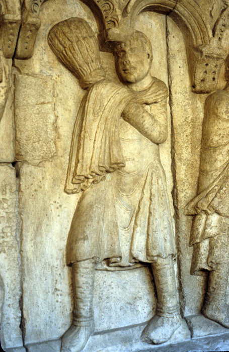 Exterior west, bay 4, frieze 3, Cain holding wheat, early 12c., Wiligelmo