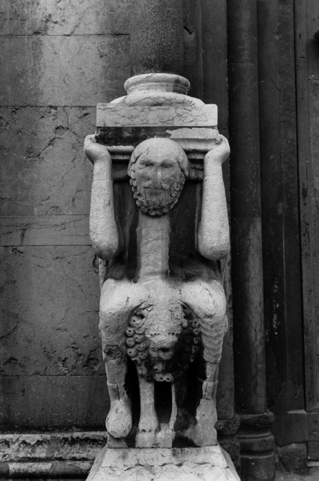 Exterior west, left porch, left supporting figure, 1122-1130, attributed to Wiligelmo