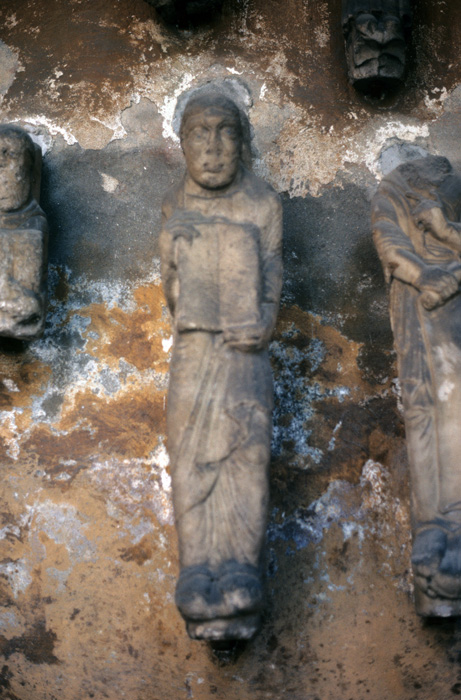 Statue, male figure holding book